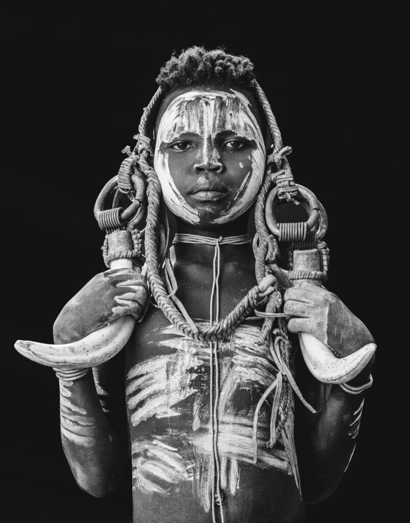 A young Mursi girl wears a headdress called a Nilla.