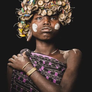 A young girl from the Mursi Tribe stands proudly.