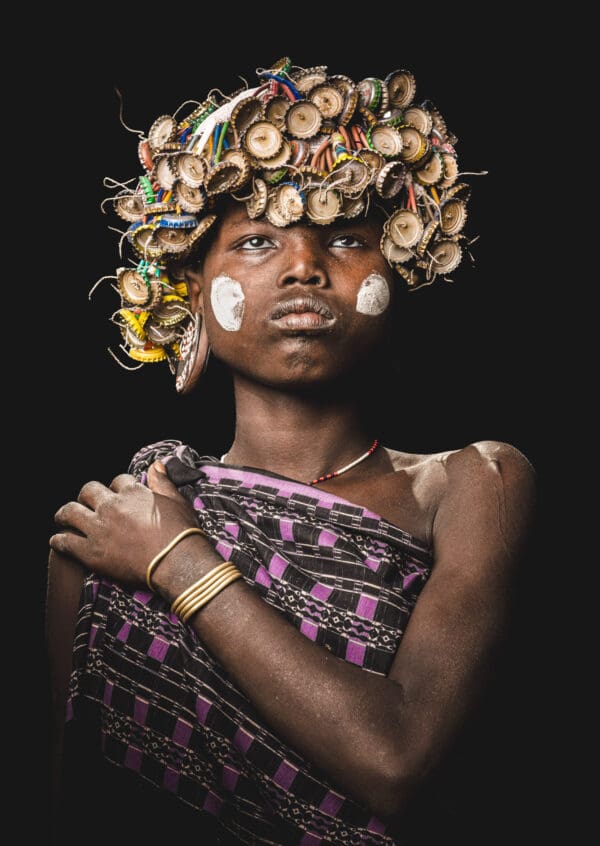 A young girl from the Mursi Tribe stands proudly.